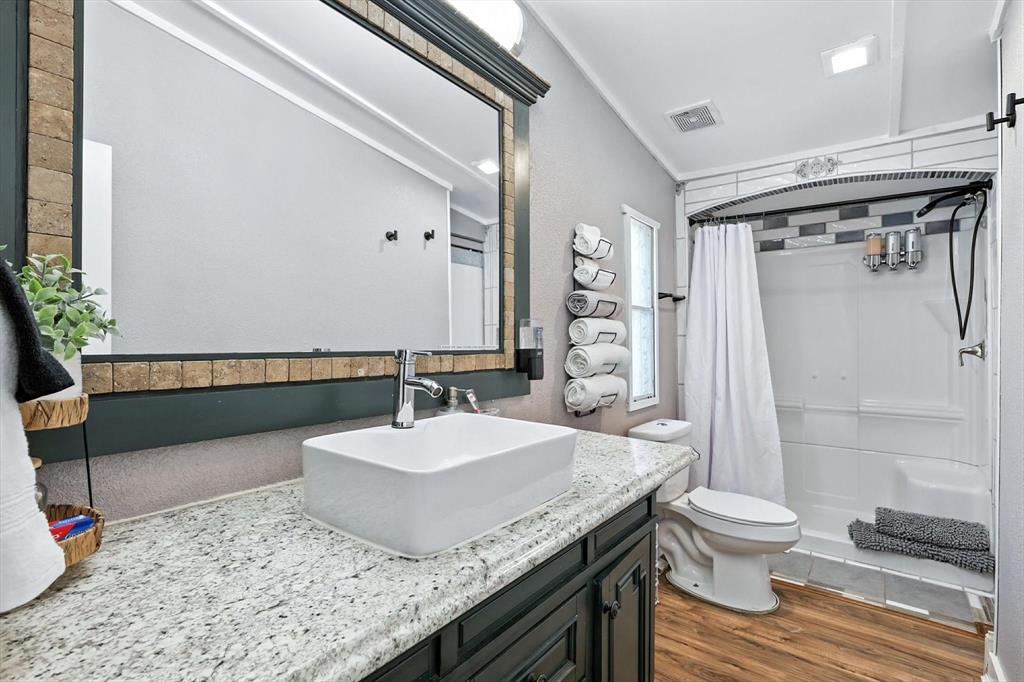 150 Red Bluff Loop Mabank, TX 75156 - Photo 22 of 26 a bathroom with a granite countertop sink toilet and shower
