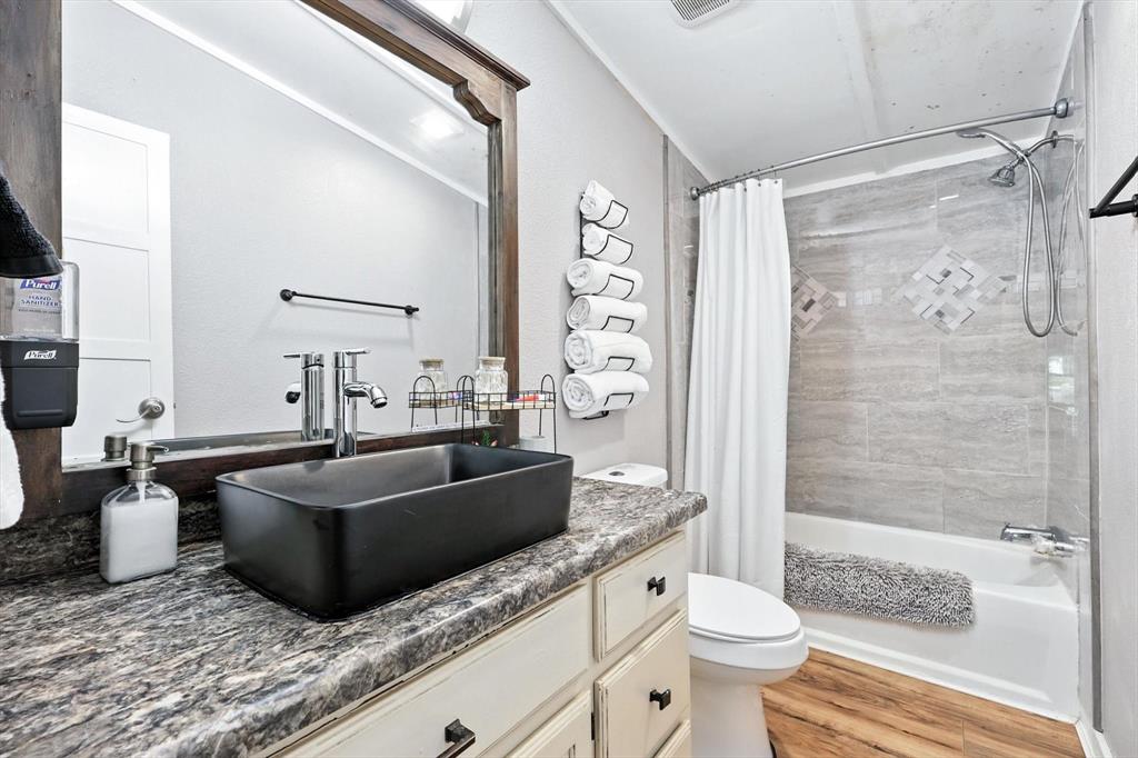 150 Red Bluff Loop Mabank, TX 75156 - Photo 25 of 26 a bathroom with a granite countertop sink a toilet a mirror and shower
