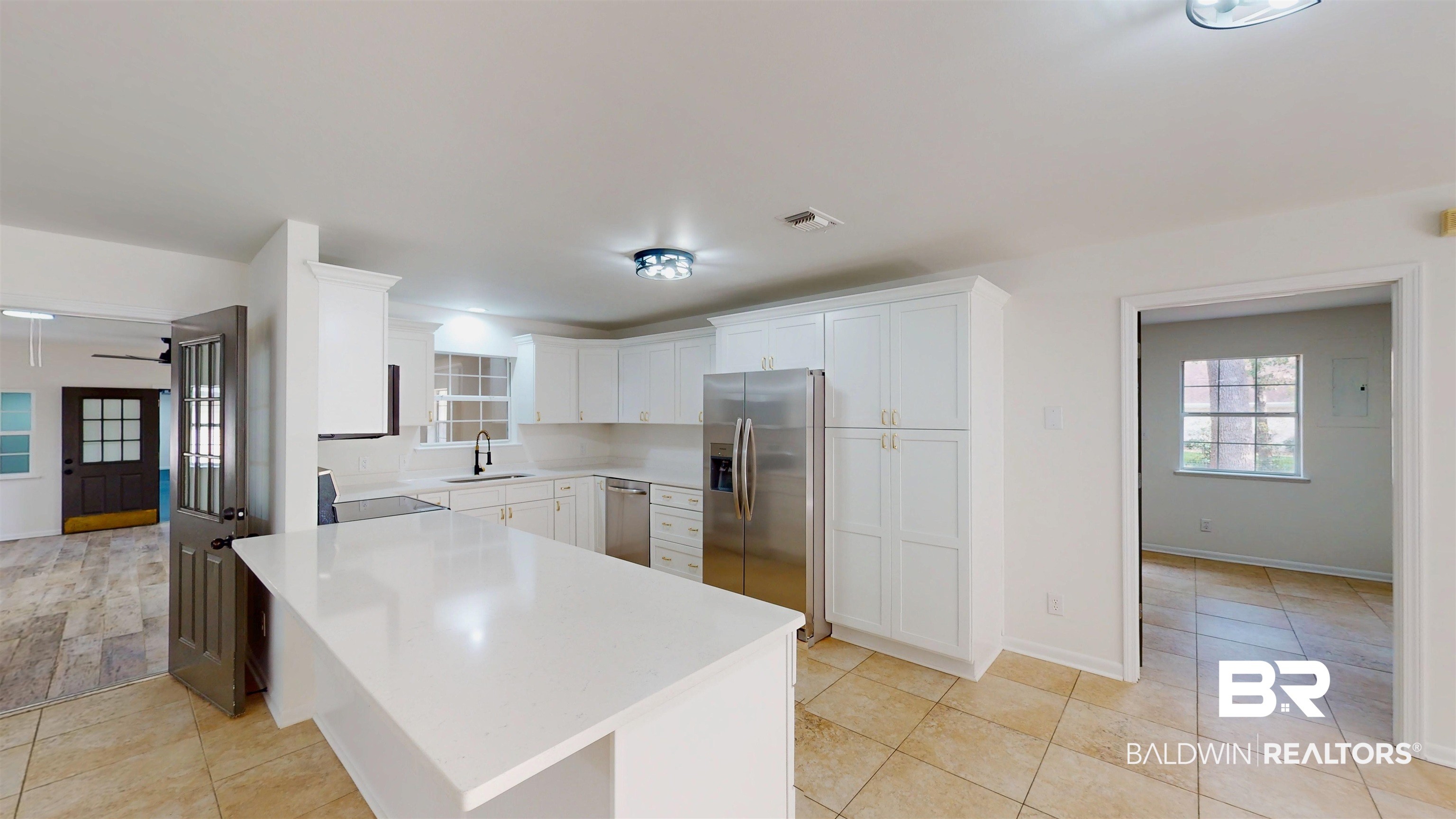 22711 Highway 98 Foley, AL 36535 - Photo 12 of 74 Kitchen featuring white cabinetry, appliances with stainless steel finishes, light stone countertops, and light tile patterned flooring