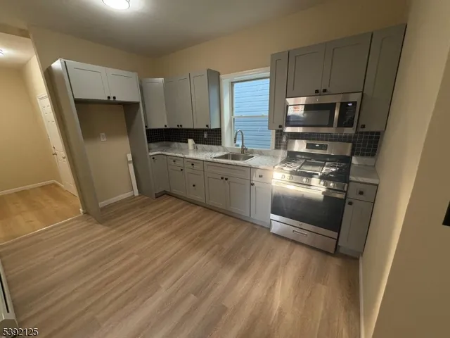 a kitchen with wooden cabinets and stainless steel appliances
