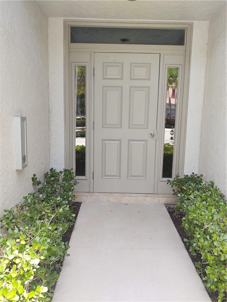 5801 Coach House Circle, Unit B Boca Raton, FL 33486 - Photo 3 of 39 Walking up to the secure lobby