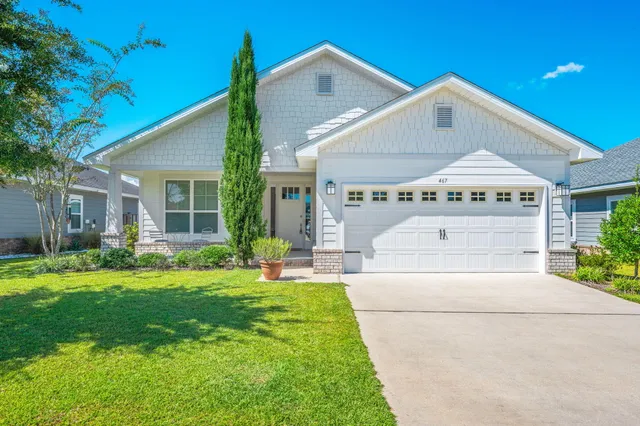 a front view of a house with a yard and porch