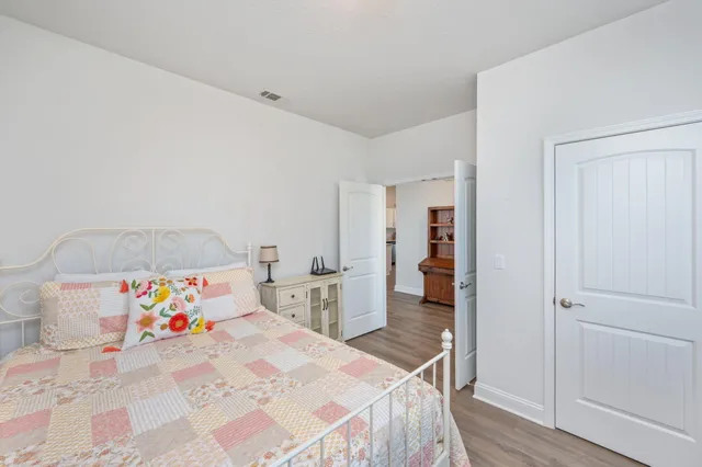 a bedroom with a bed and a painting on the wall