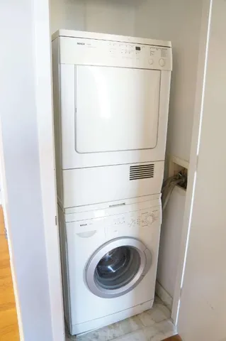 a spacious bedroom with a bed and a large window