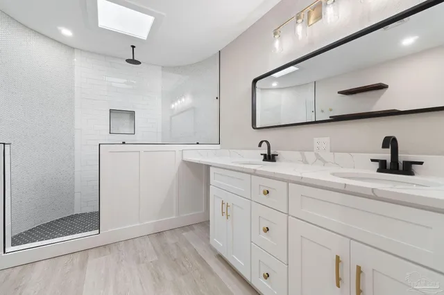 a bathroom with a double vanity sink and mirror
