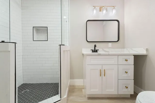 a bathroom with a sink vanity and mirror