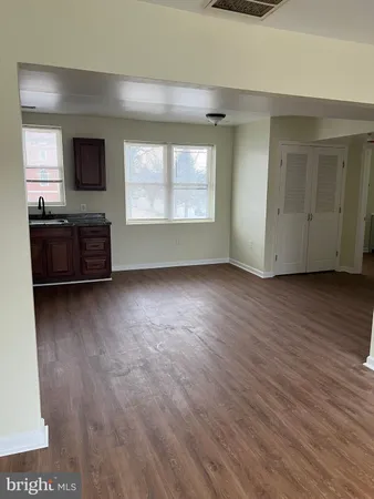 a view of a livingroom with furniture wooden floor and window