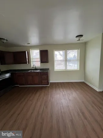 a living room with hard wood floors and a fireplace