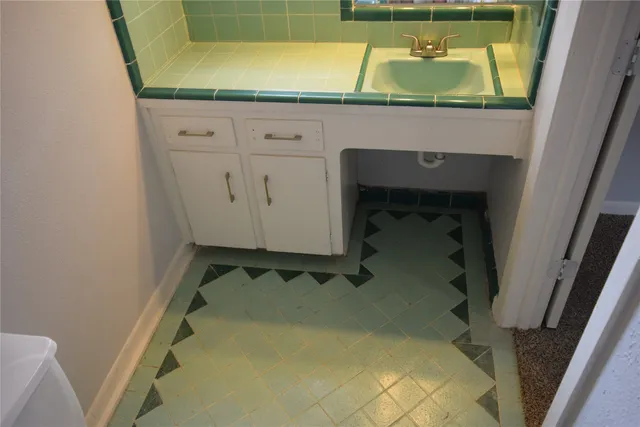 a room with a sink and cabinets