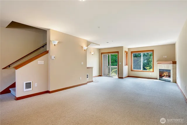 a view of a livingroom with an empty space and a fireplace