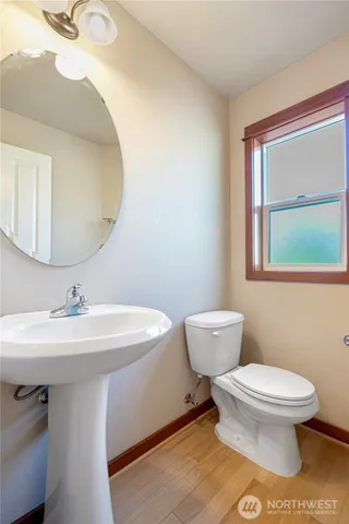 a bathroom with a toilet sink and mirror
