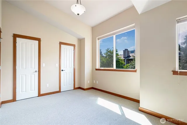 an empty room with windows and closet