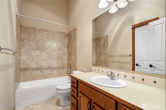 a bathroom with a double vanity sink toilet and shower