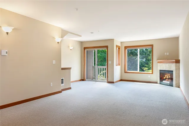 a view of a livingroom with an empty space and a fireplace