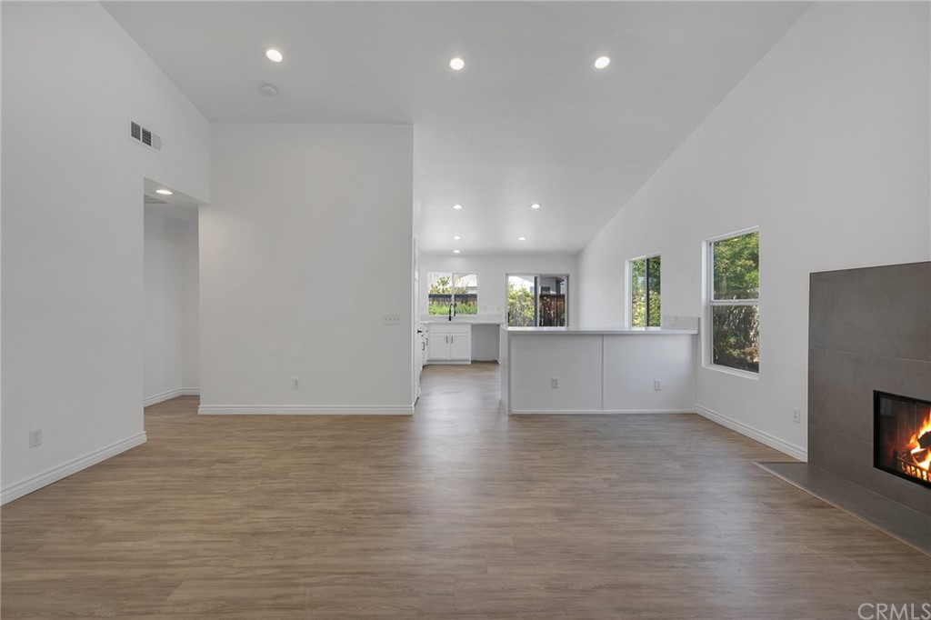 175 Paperbirch Circle Corona, CA 92881 - Photo 13 of 33 an empty room with wooden floor fireplace and windows