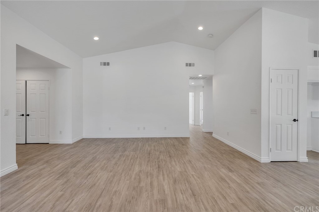 175 Paperbirch Circle Corona, CA 92881 - Photo 15 of 33 an empty room with wooden floor and windows
