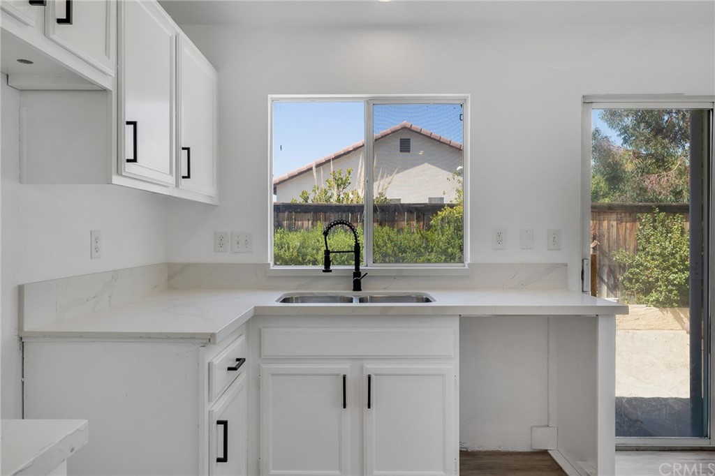 175 Paperbirch Circle Corona, CA 92881 - Photo 20 of 33 a kitchen with stainless steel appliances a sink and a window