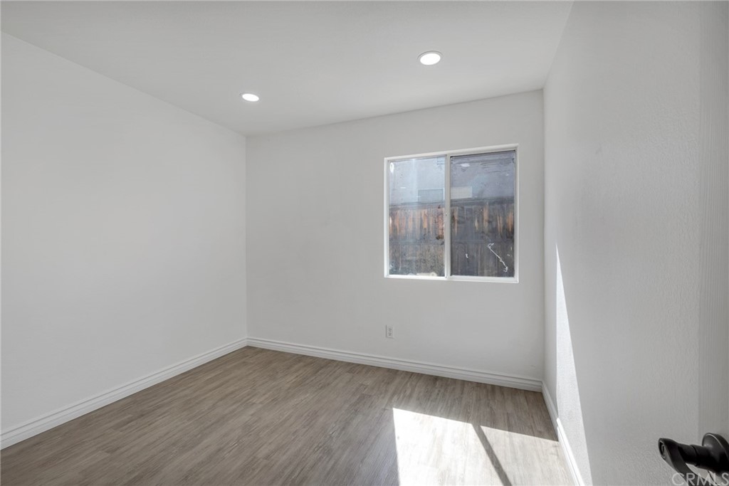 175 Paperbirch Circle Corona, CA 92881 - Photo 23 of 33 an empty room with wooden floor and windows