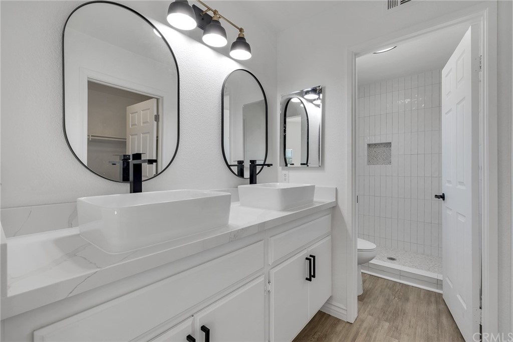 175 Paperbirch Circle Corona, CA 92881 - Photo 29 of 33 a bathroom with a double vanity sink and a mirror
