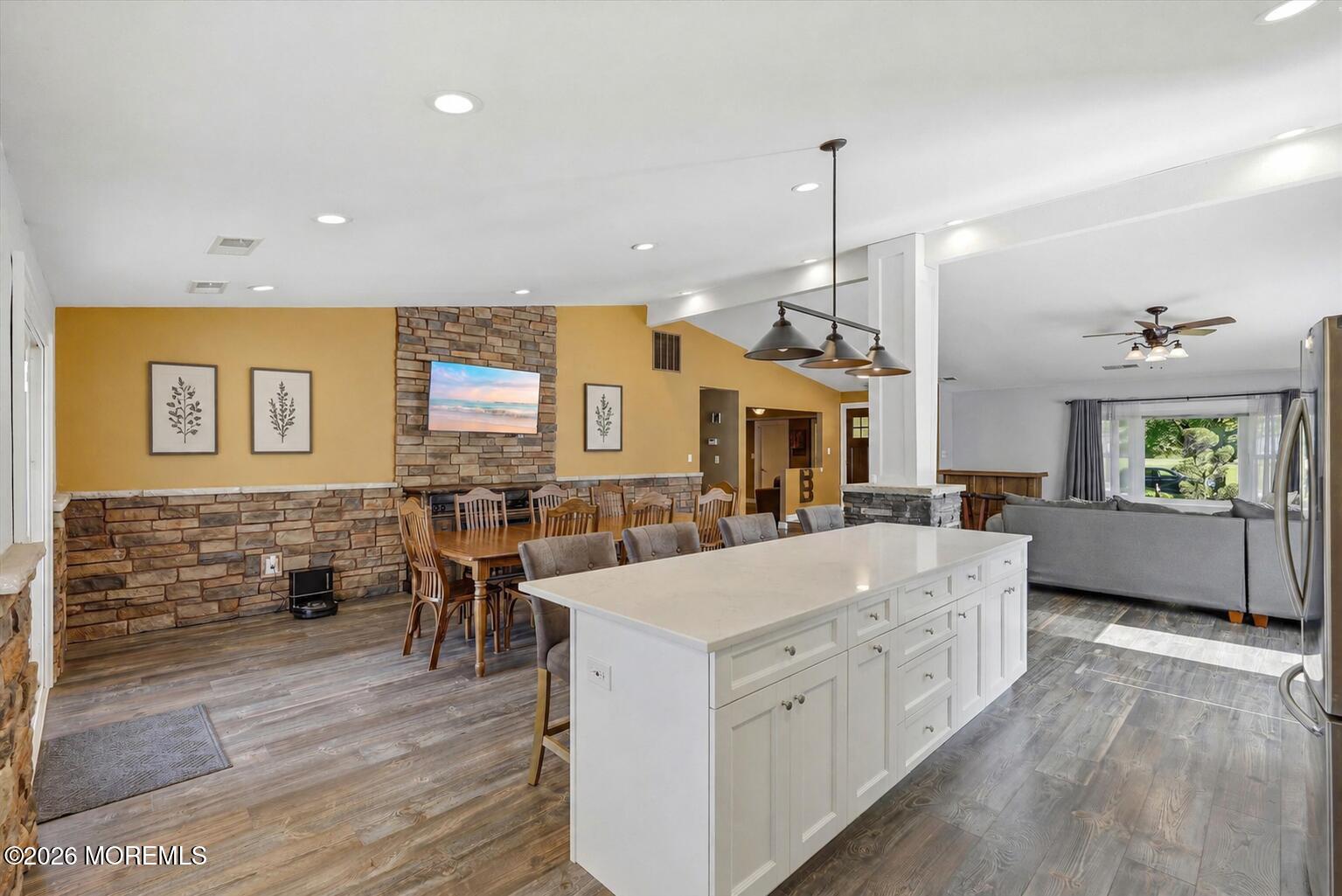 22 Ethan Allen Road Freehold, NJ 07728 - Photo 14 of 31 a large white kitchen with a large island oven a stove and a wooden floors
