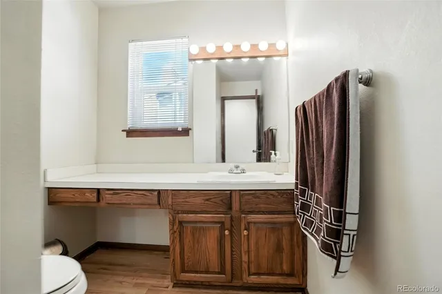 an empty room with windows and ceiling fan