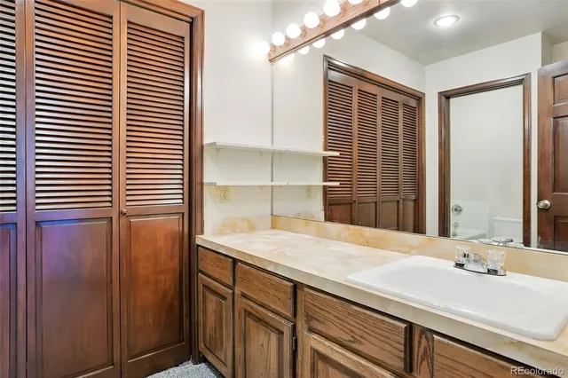 a bathroom with a glass shower door and a sink