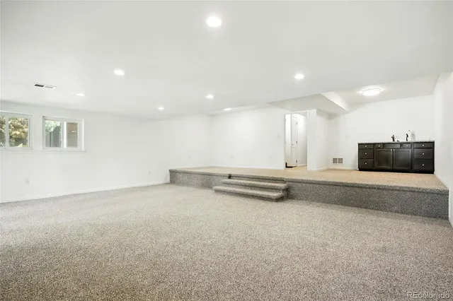 an empty room with windows and closet