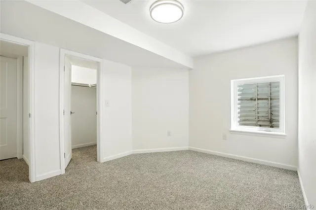 a bathroom with a granite countertop sink toilet a mirror and shower