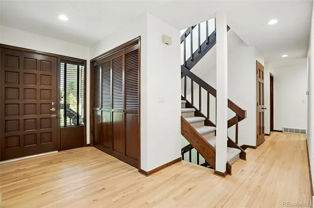 a view of an entryway with wooden floor and stairs