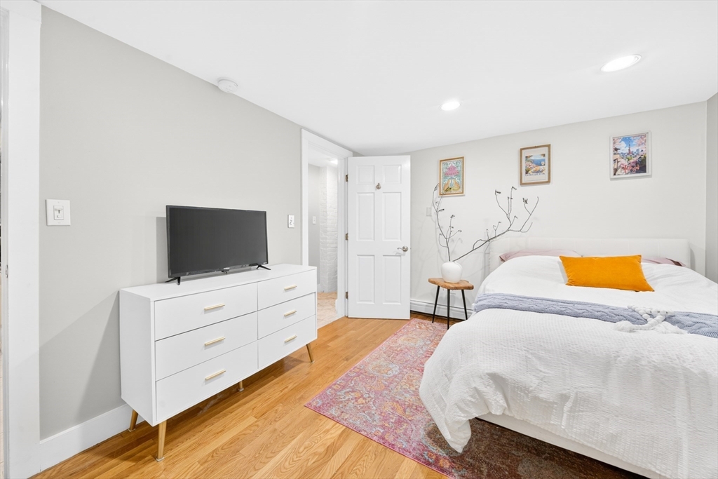 352 Tappan Street, Unit 1 Brookline, MA 02445 - Photo 25 of 42 a bedroom with a bed and a flat screen tv