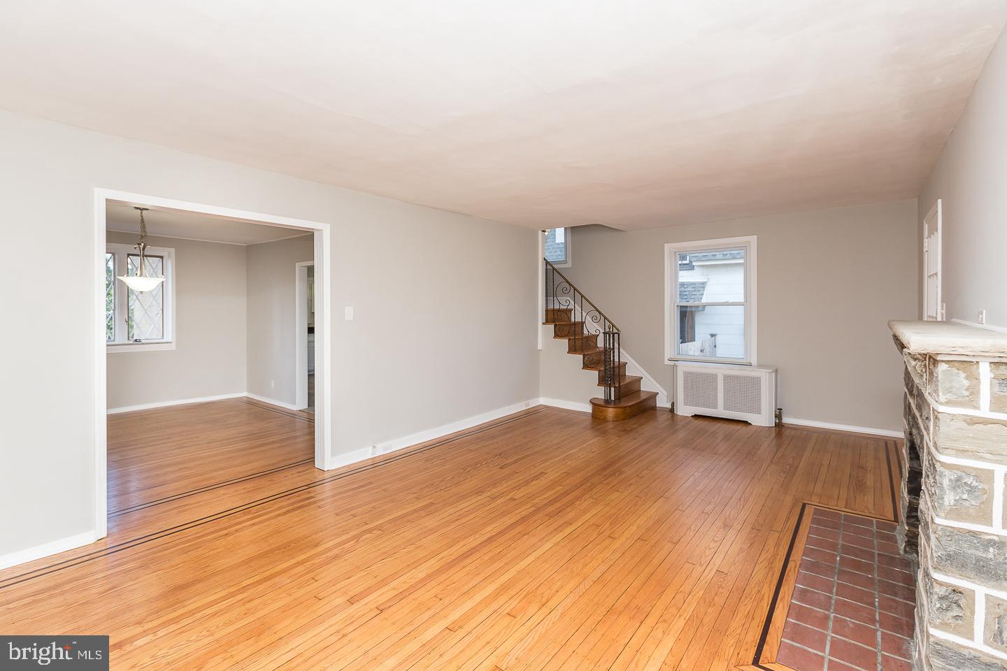 136 Shelbourne Road Havertown, PA 19083 - Photo 12 of 48 an empty room with wooden floor and stairs