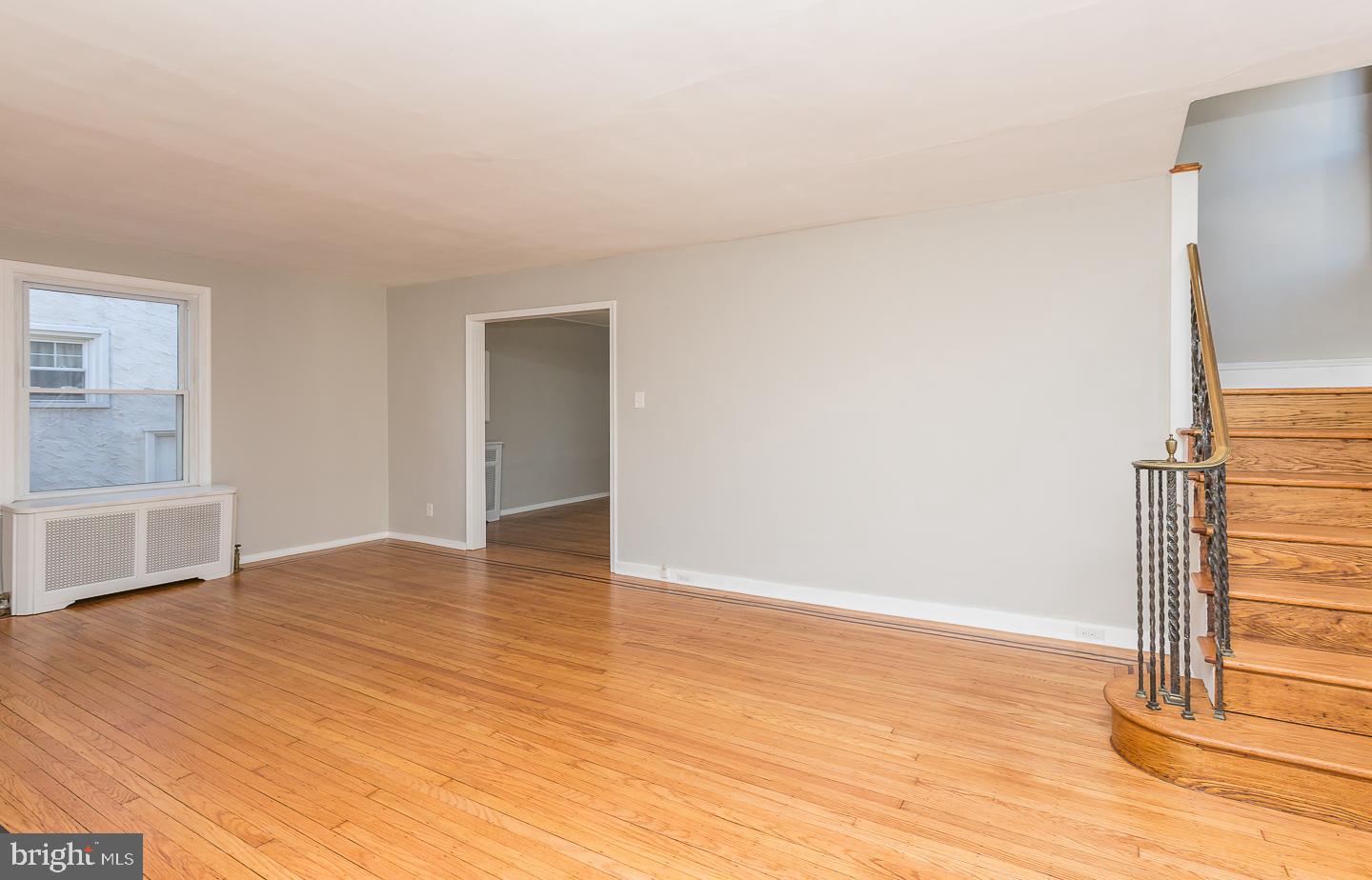 136 Shelbourne Road Havertown, PA 19083 - Photo 13 of 48 a view of an empty room with wooden floor and a window