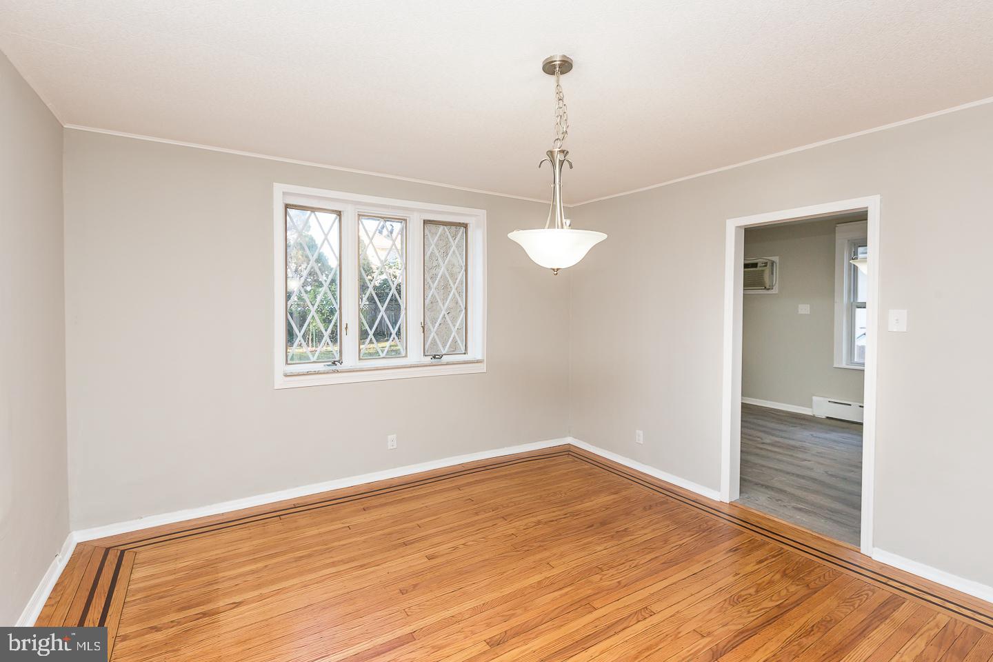 136 Shelbourne Road Havertown, PA 19083 - Photo 15 of 48 a view of an empty room with wooden floor and a window