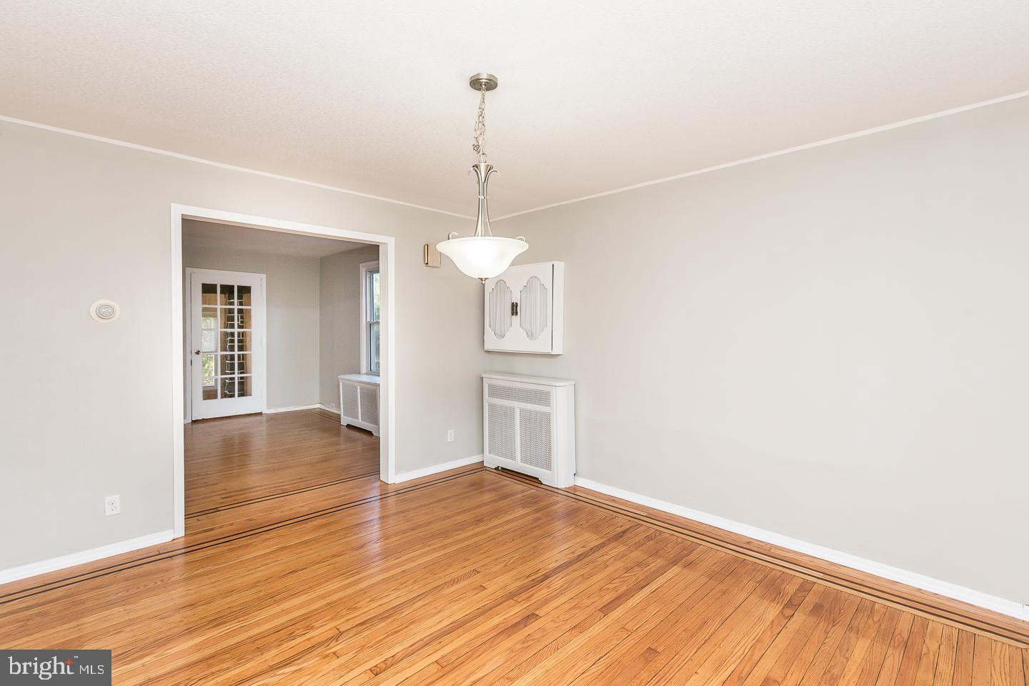 136 Shelbourne Road Havertown, PA 19083 - Photo 17 of 48 a view of empty room with wooden floor and kitchen view