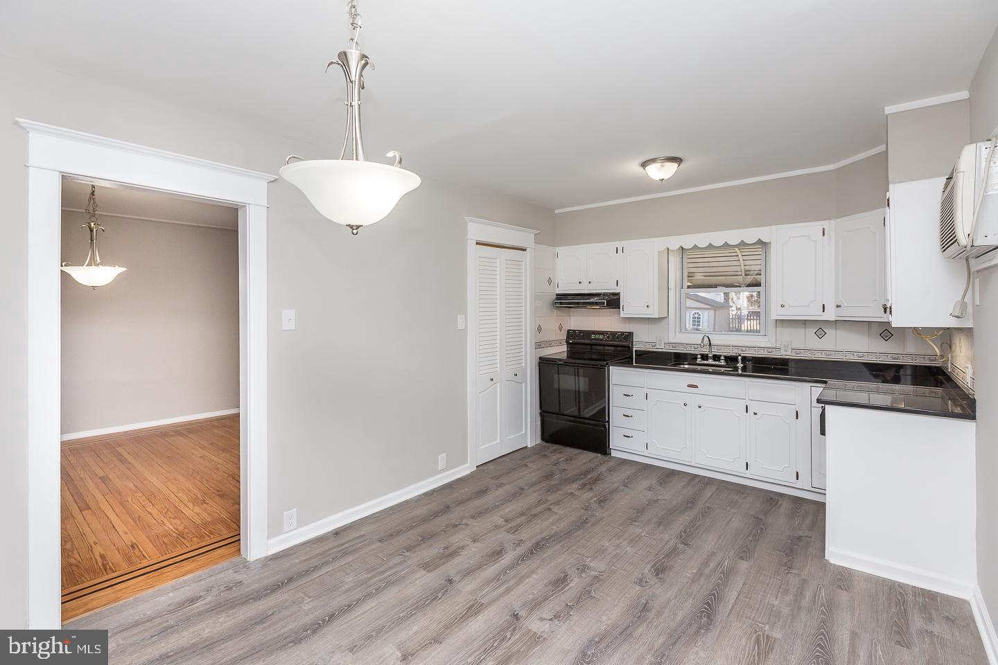 136 Shelbourne Road Havertown, PA 19083 - Photo 20 of 48 a kitchen with granite countertop a refrigerator and white cabinets