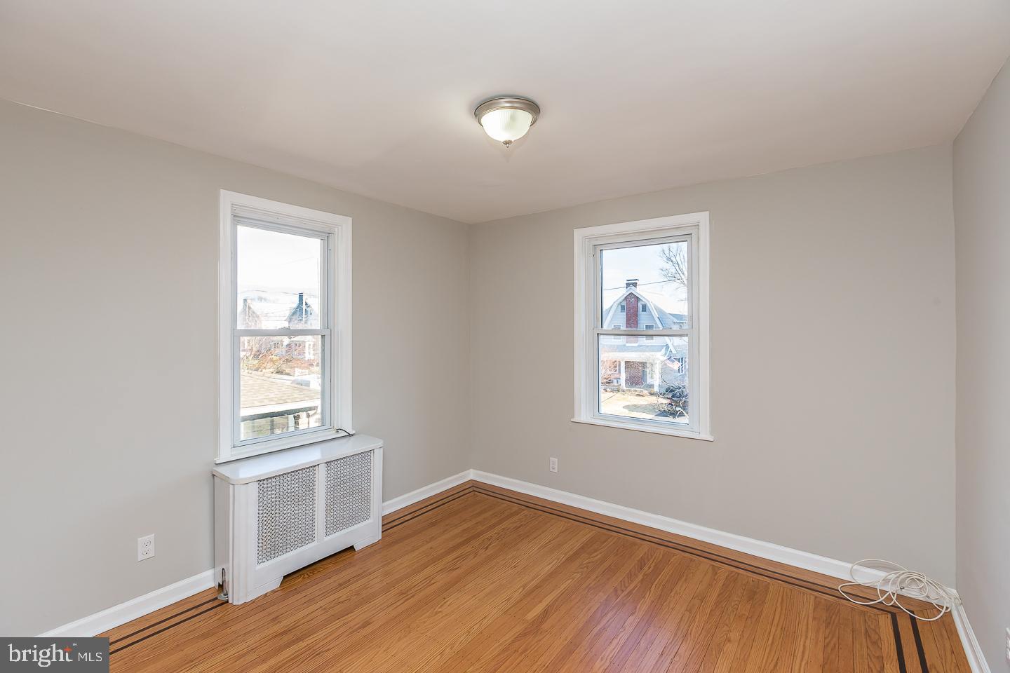 136 Shelbourne Road Havertown, PA 19083 - Photo 25 of 48 a view of an empty room with wooden floor and a window