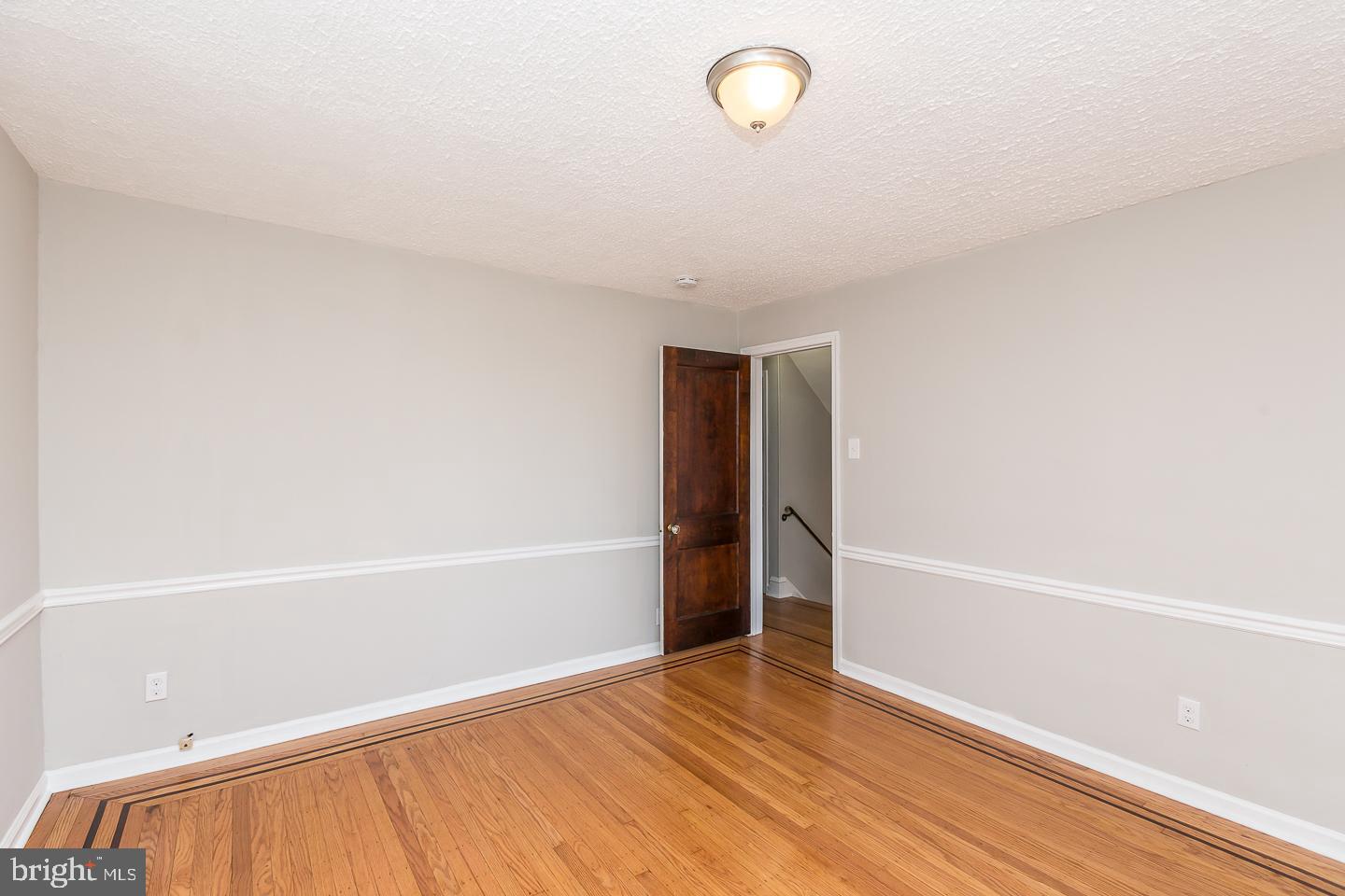 136 Shelbourne Road Havertown, PA 19083 - Photo 28 of 48 a view of an empty room with wooden floor and a window