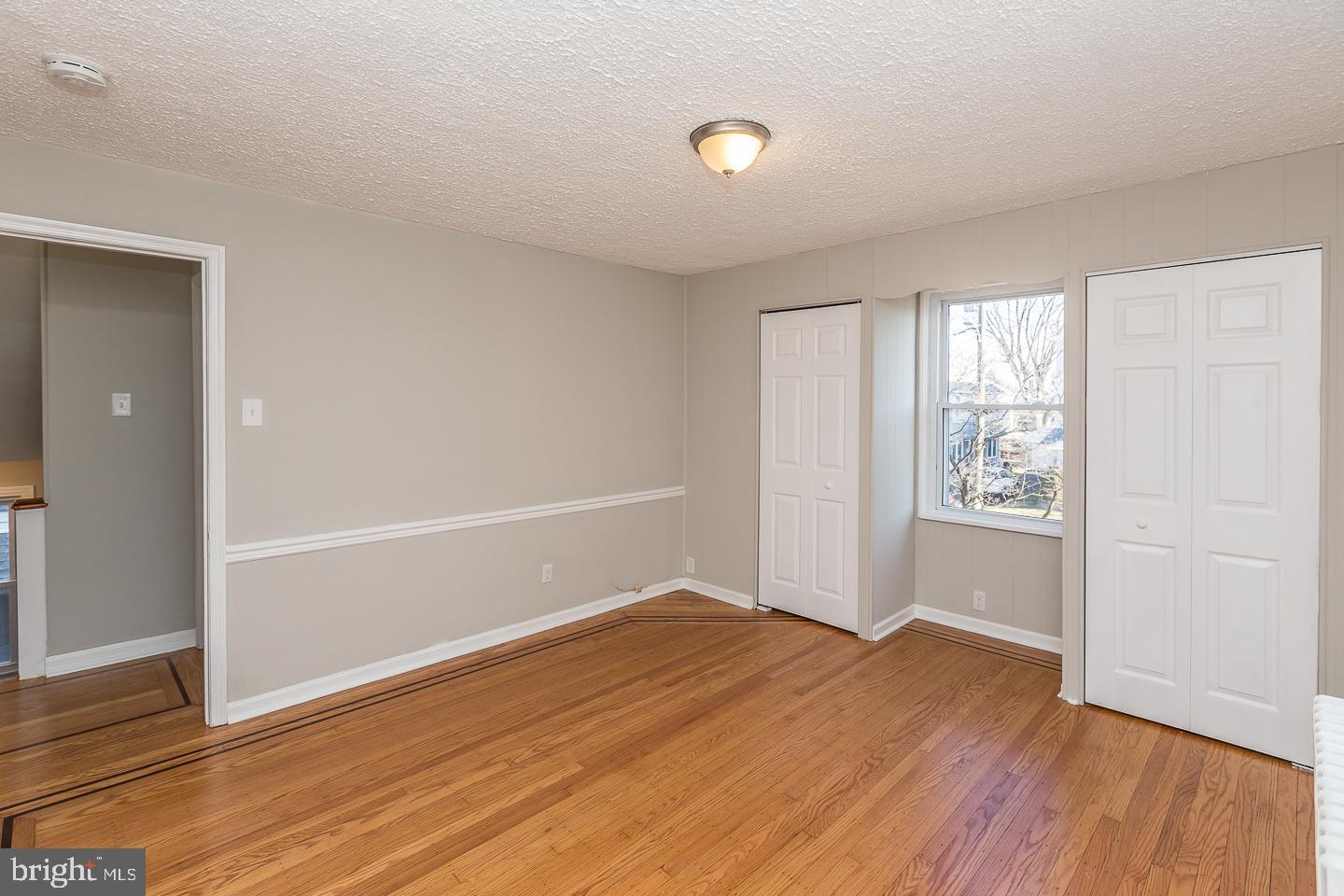 136 Shelbourne Road Havertown, PA 19083 - Photo 29 of 48 an empty room with wooden floor and windows