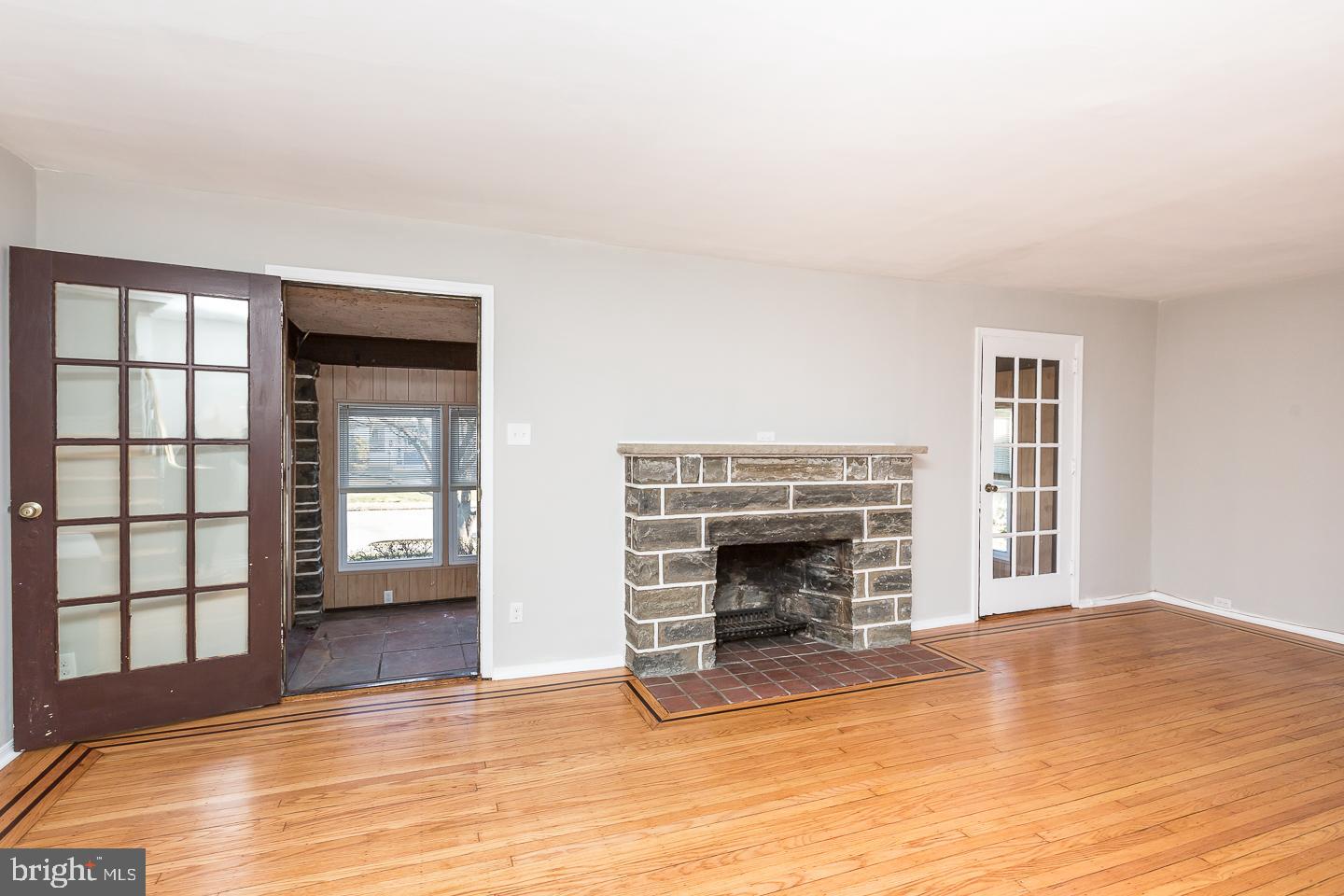 136 Shelbourne Road Havertown, PA 19083 - Photo 10 of 48 a view of an empty room with glass door and wooden floor
