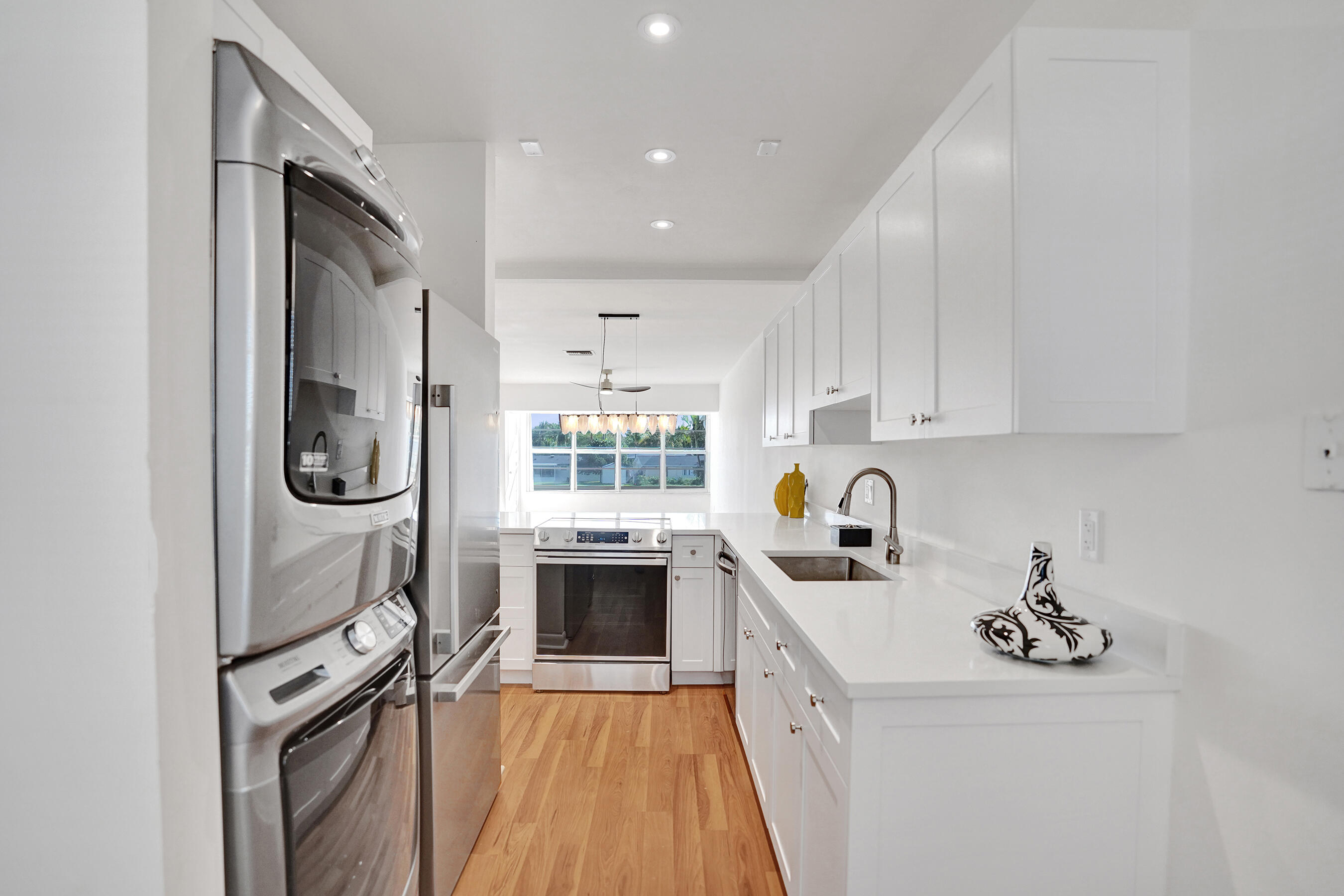 a kitchen with granite countertop a sink and stove top oven