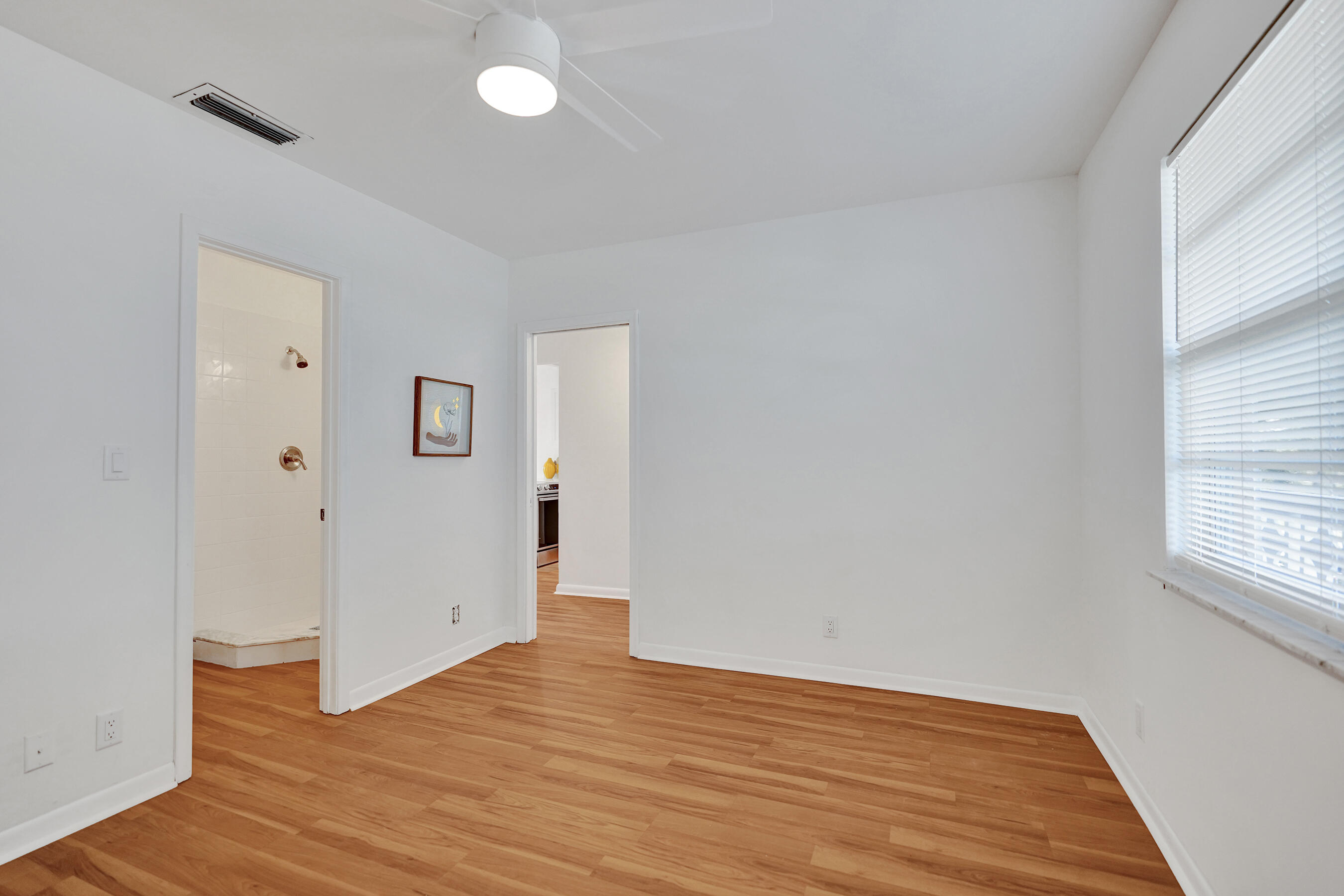 1130 Mahogany Way, Unit 203 Delray Beach, FL 33445 - Photo 21 of 34 an empty room with wooden floor and windows
