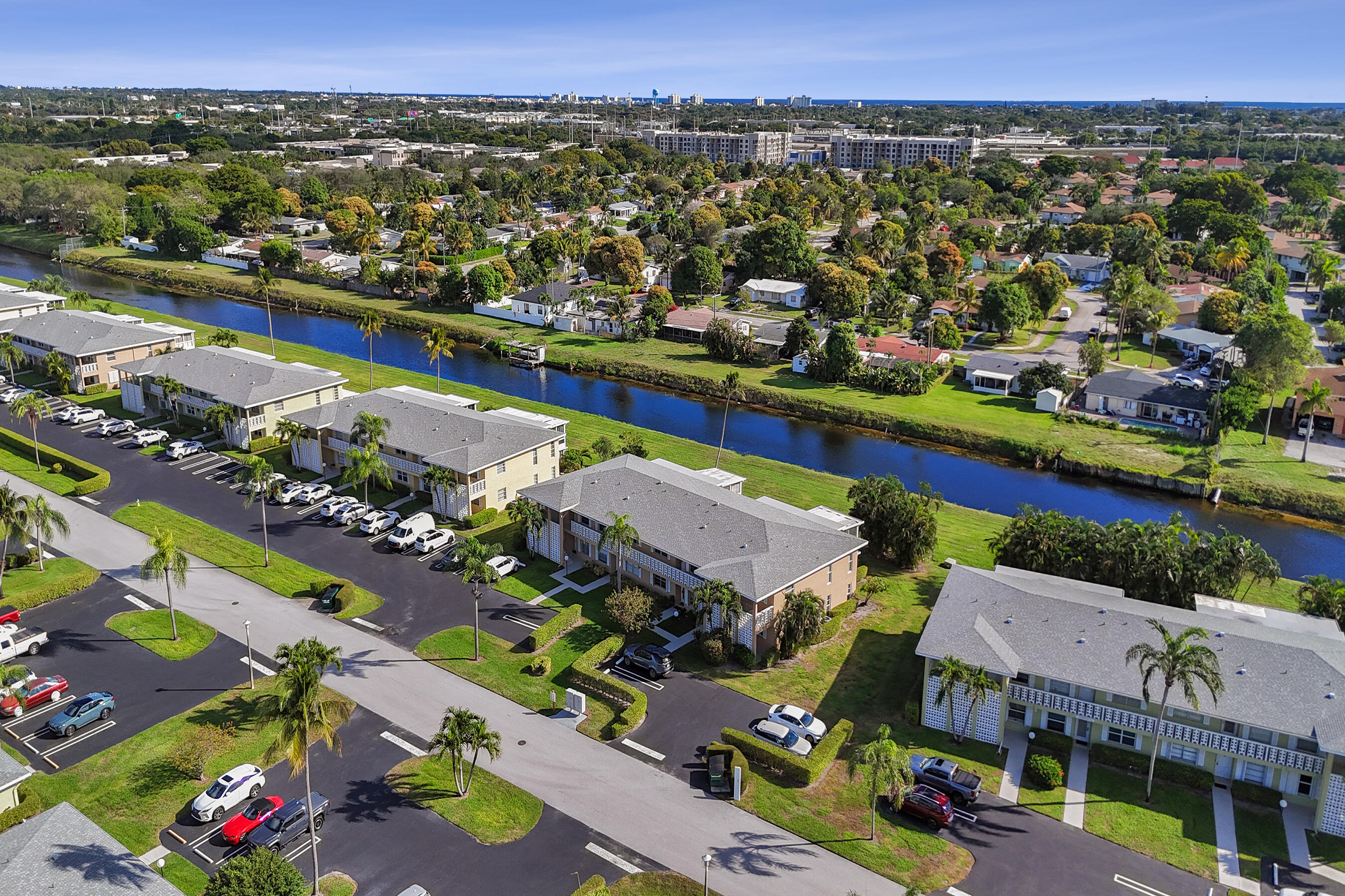 1130 Mahogany Way, Unit 203 Delray Beach, FL 33445 - Photo 25 of 34 an aerial view of a houses with a swimming pool