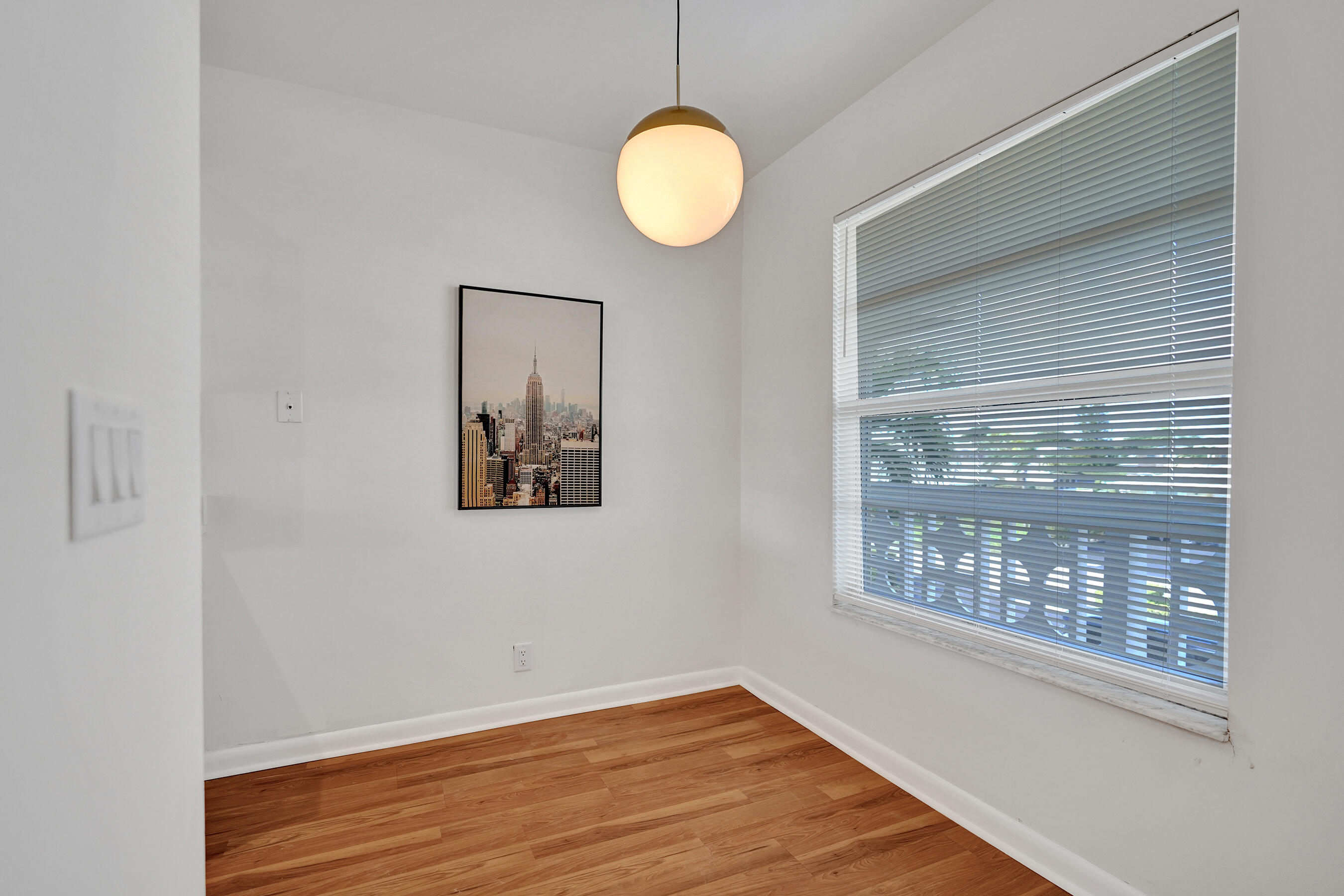 1130 Mahogany Way, Unit 203 Delray Beach, FL 33445 - Photo 5 of 34 a view of a room with wooden floor and windows