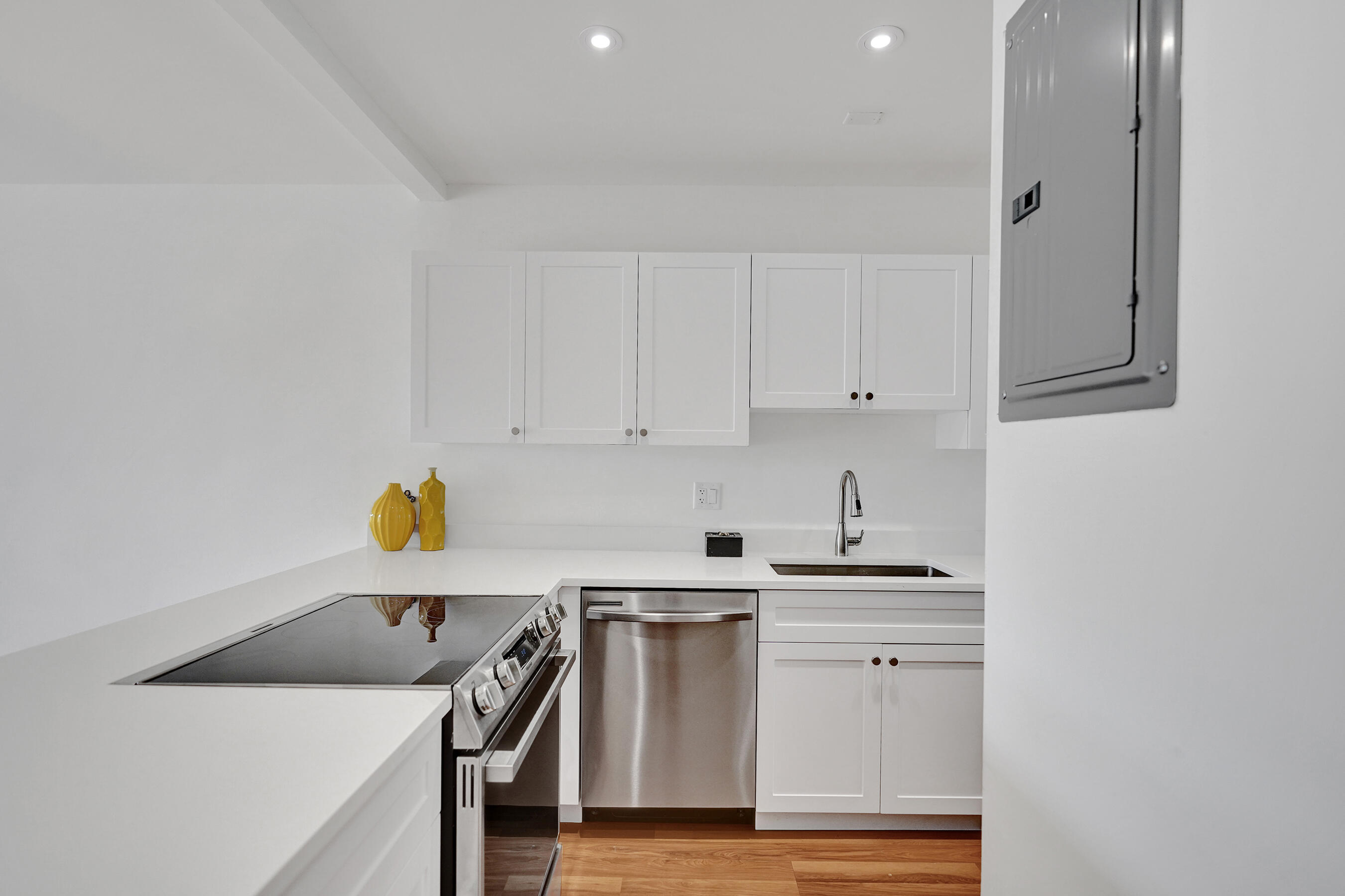 1130 Mahogany Way, Unit 203 Delray Beach, FL 33445 - Photo 6 of 34 a kitchen with white cabinets and sink