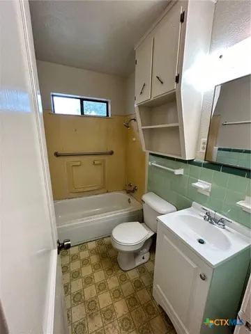 a bathroom with a sink toilet and tub
