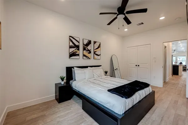 a bedroom with a bed and a ceiling fan