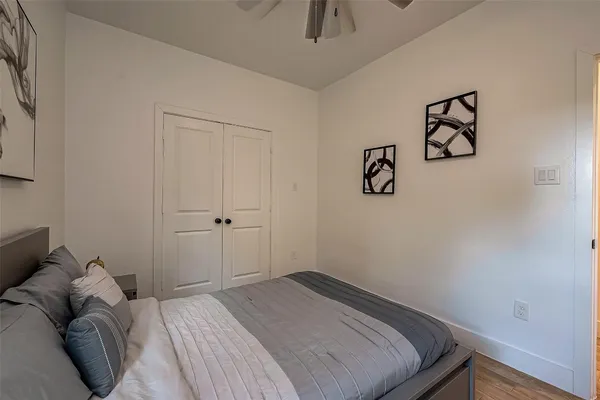 a bedroom with a bed and painting on the wall