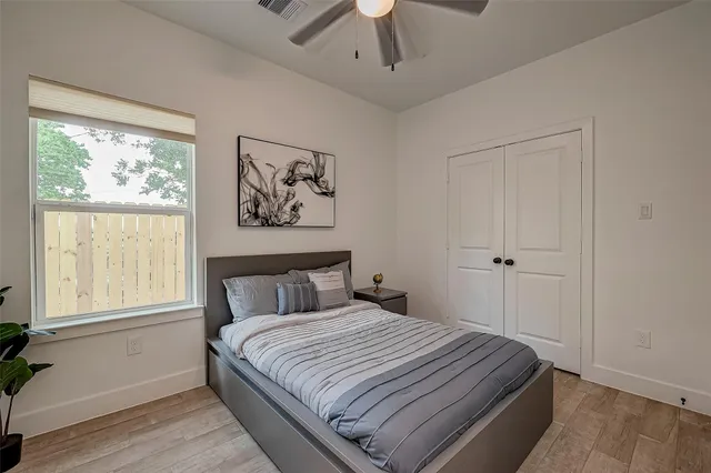 a bedroom with a large bed and a window