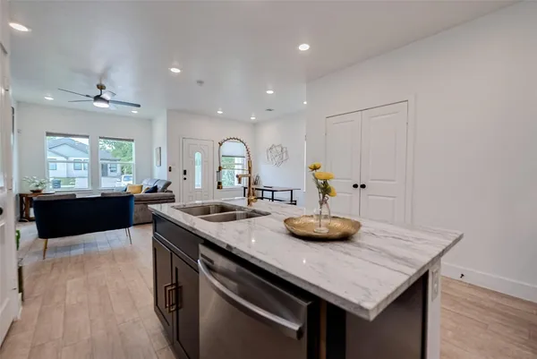 a kitchen with kitchen island a stove and a wooden floors
