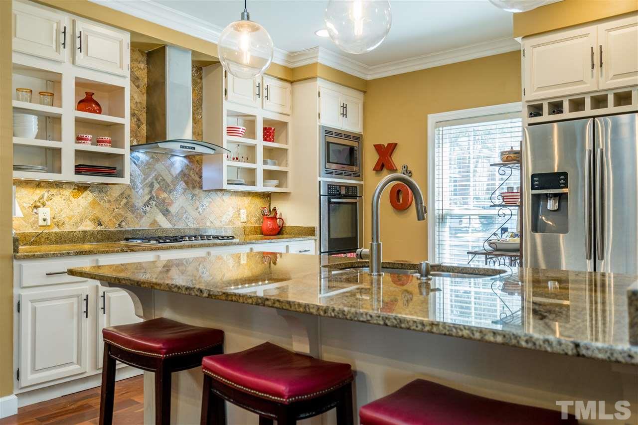 717 Weathergreen Drive Raleigh, NC 27615 - Photo 11 of 30 Pendant lighting, open shelving, tile back splash, modern SS exhaust fan!
